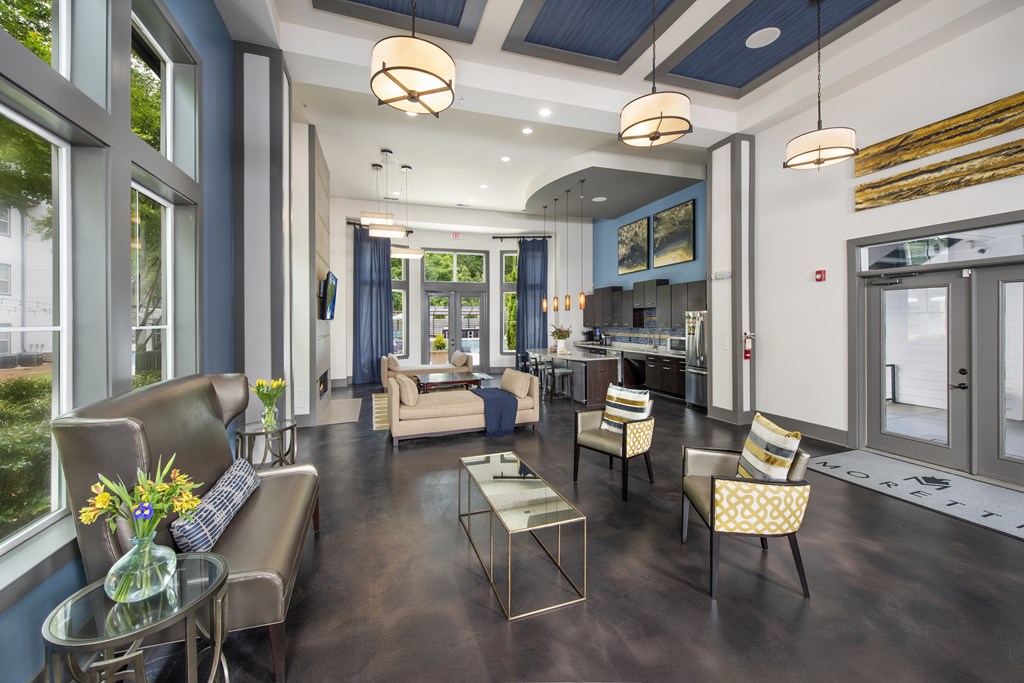 A modern living room with a glass table and chairs.