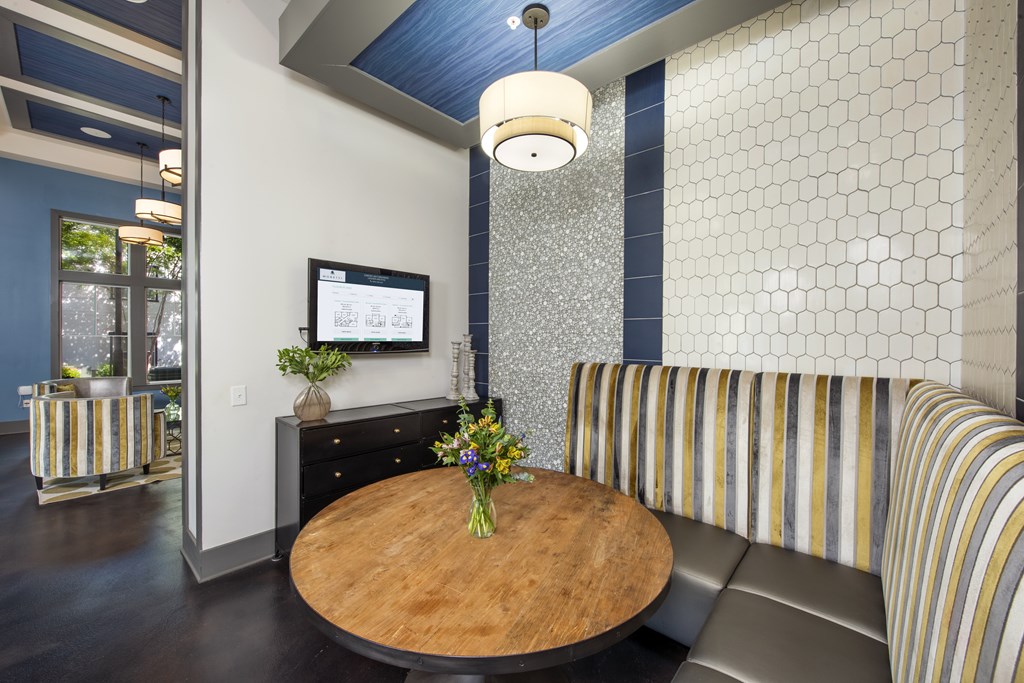 A modern living room with a wooden table and a striped sofa.