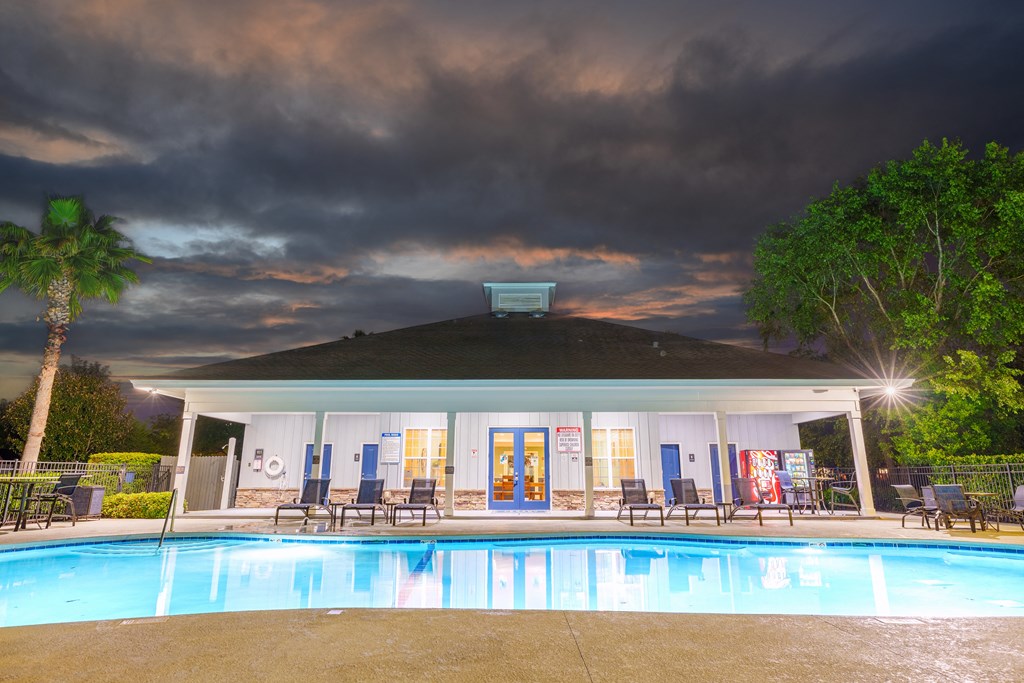the pool and pavilion at night at the resort at longboat key club