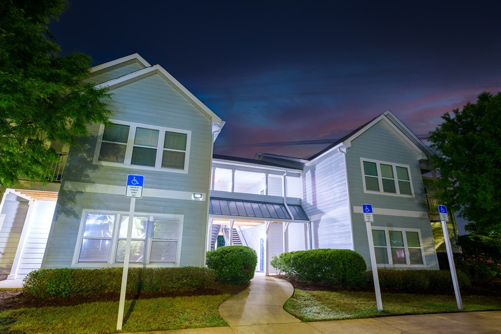 a row of town houses at night with a rainbow in the sky