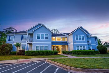 a blue house with a sidewalk in front of it