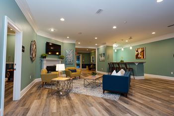 a living room with couches and chairs and a fireplace