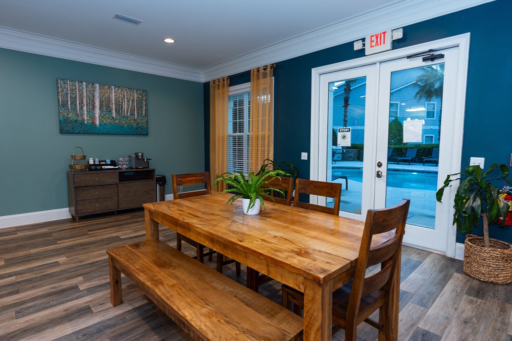 a dining room with a wooden table and chairs     and a pool