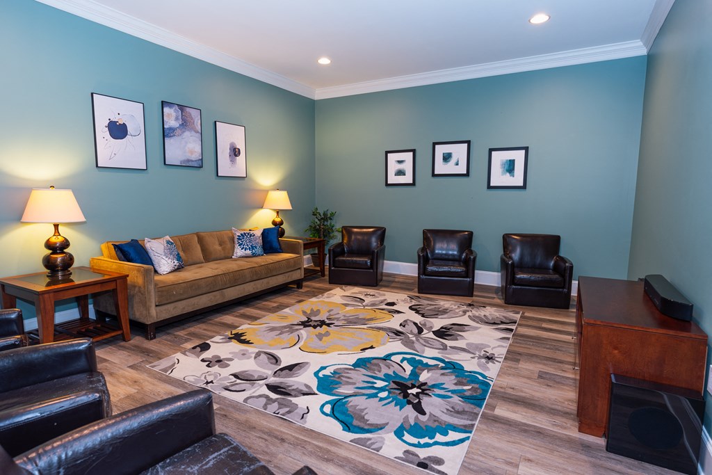 a living room with a couch and chairs and a rug