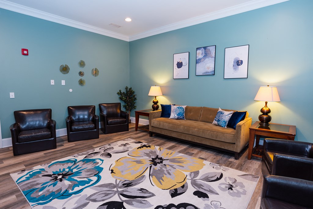 a living room with a couch and chairs and a rug