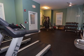 a gym with treadmills and other exercise equipment