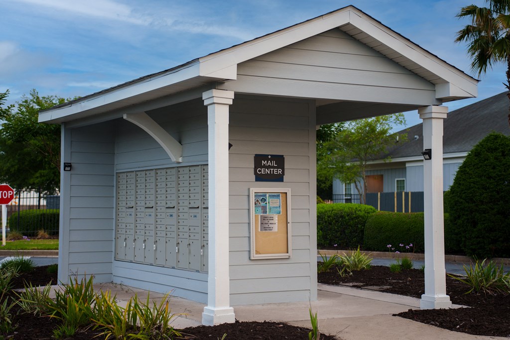 a small building with a bulletin board on the side of it