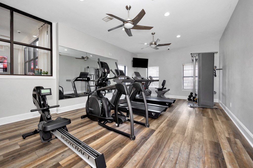 A spacious home gym with a variety of exercise equipment.