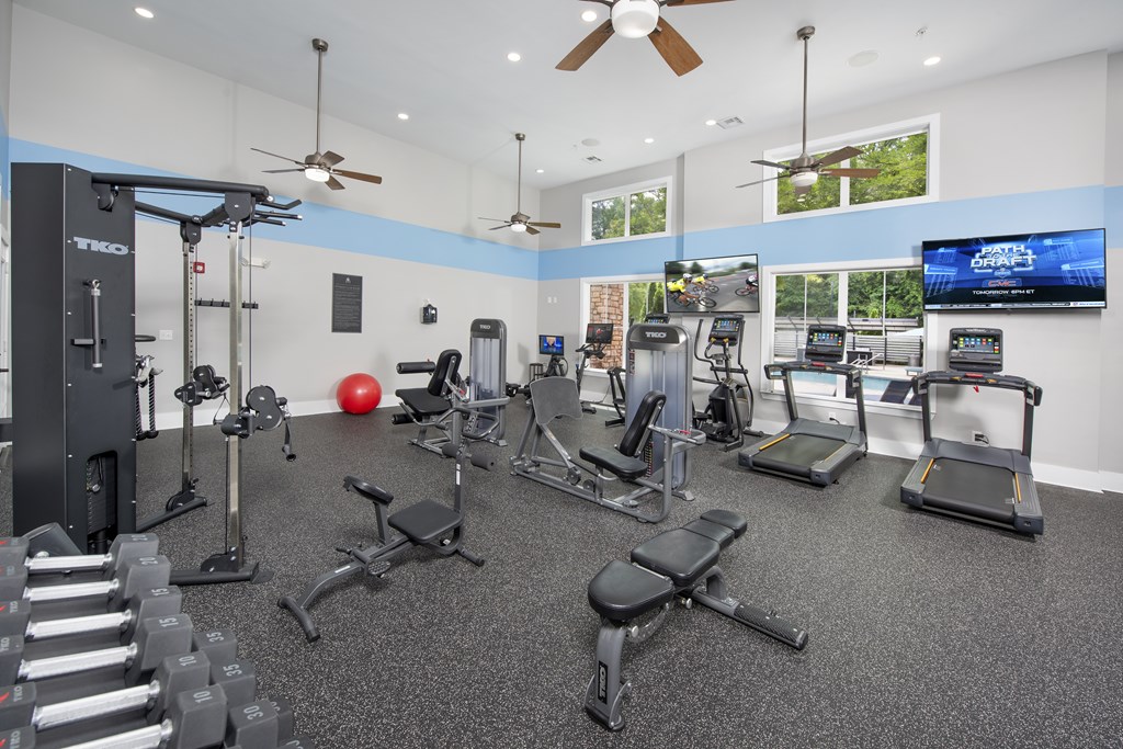 A spacious gym with a variety of equipment including treadmills, weights, and exercise machines.