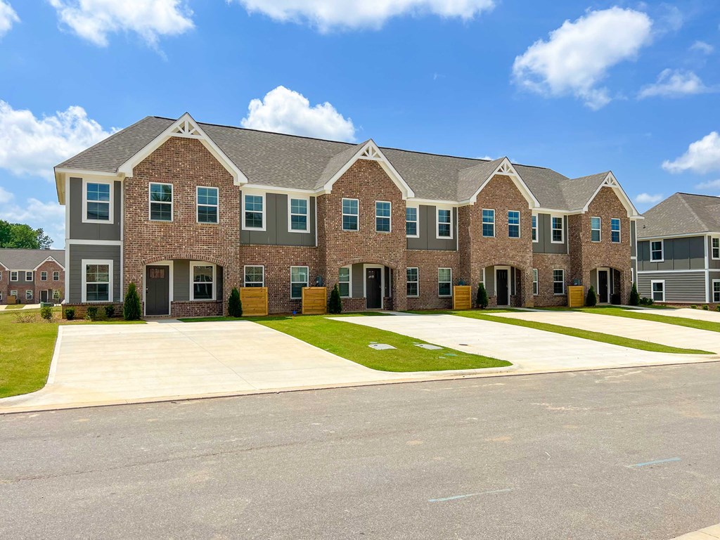 a large brick apartment building with a driveway