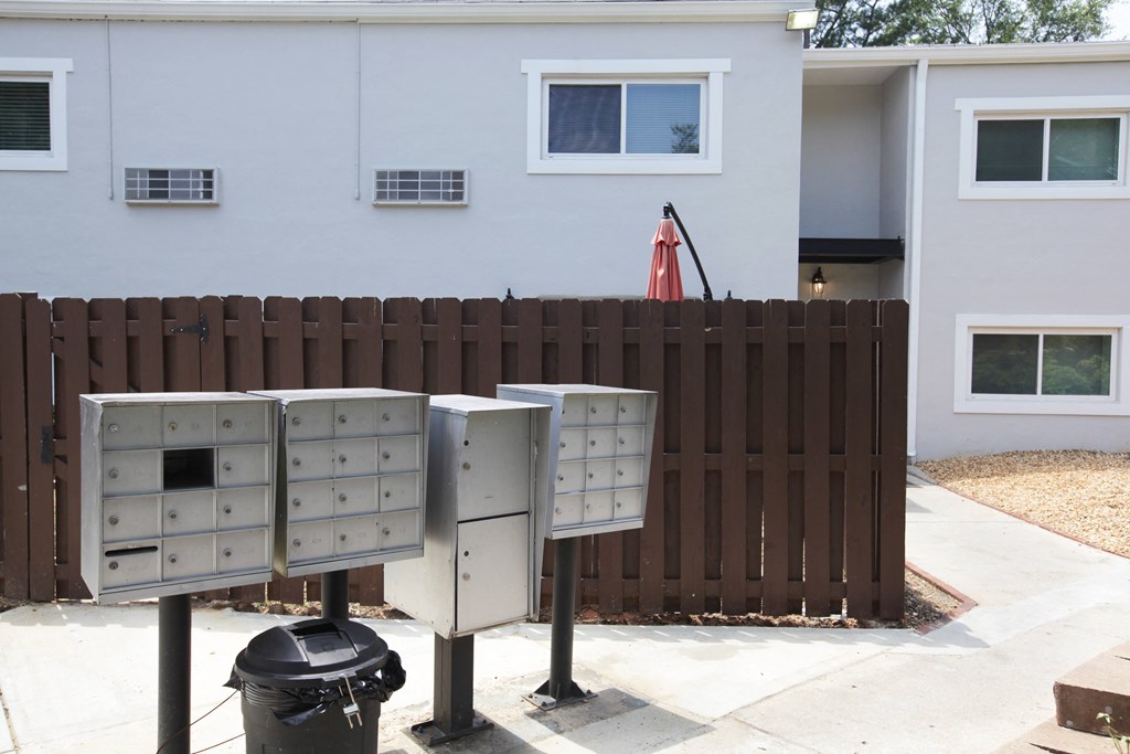 three mailboxes in front of a house