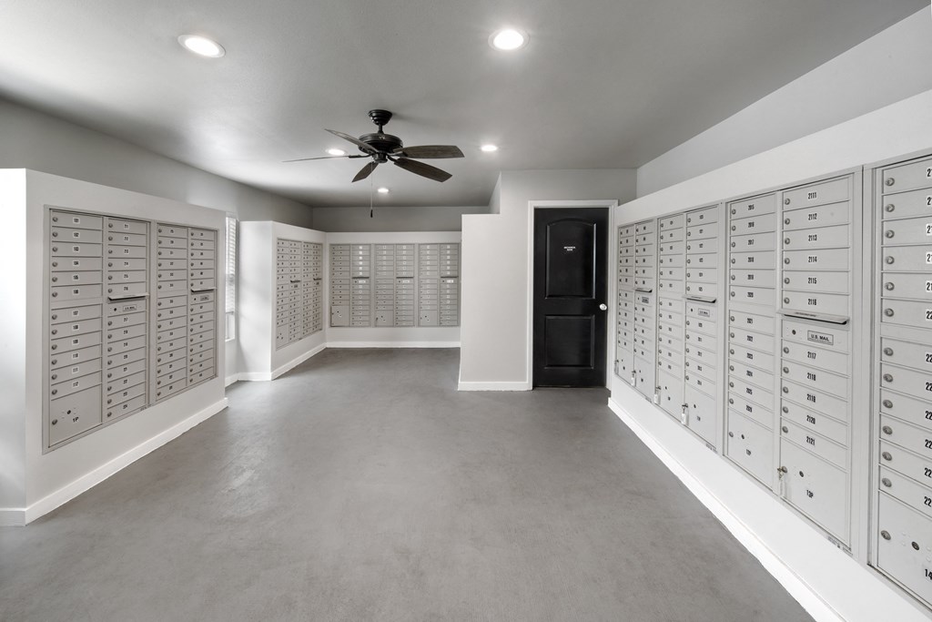 a locker room with lockers and a ceiling fan