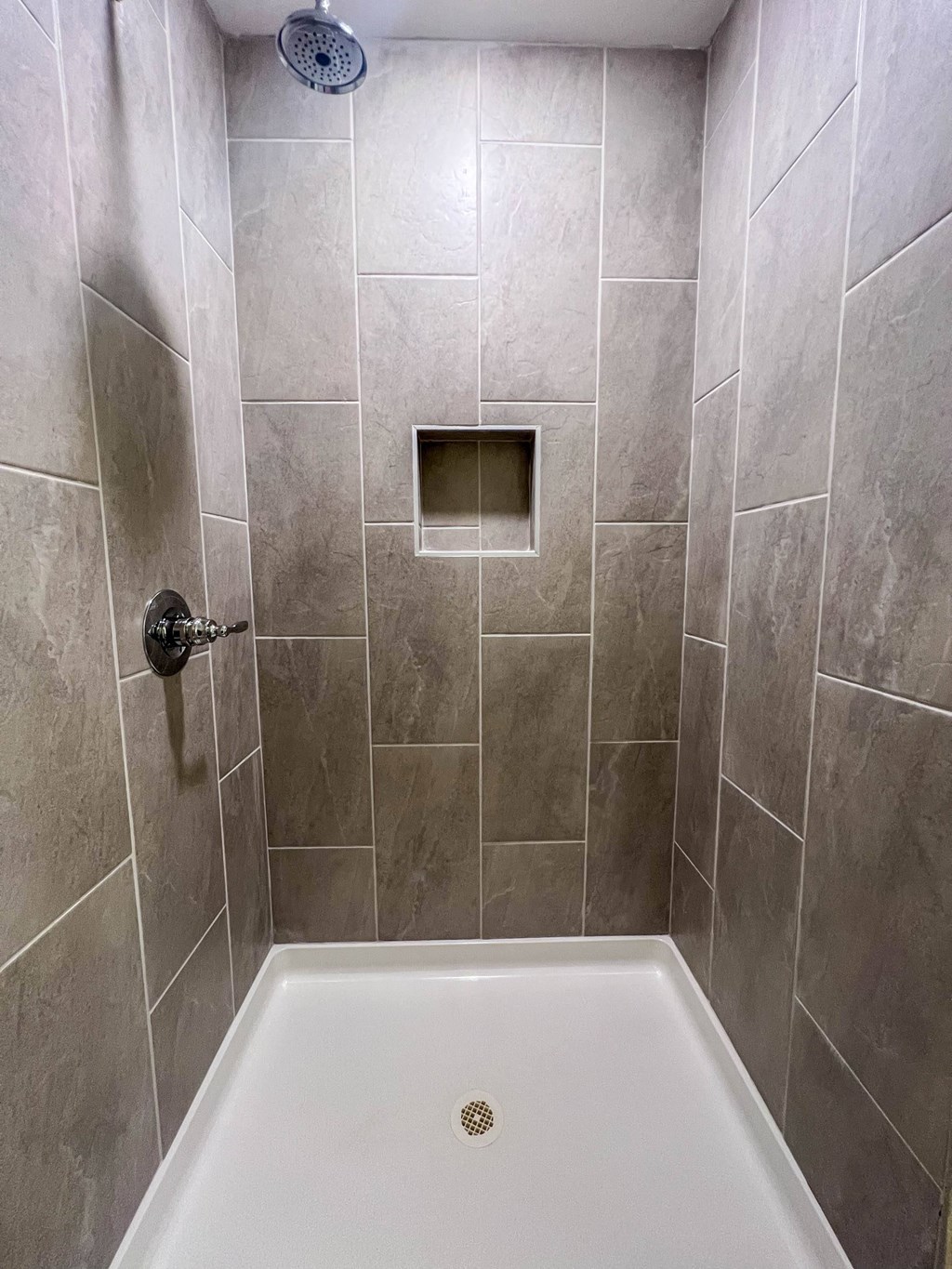 a bathroom with a shower and a bath tub