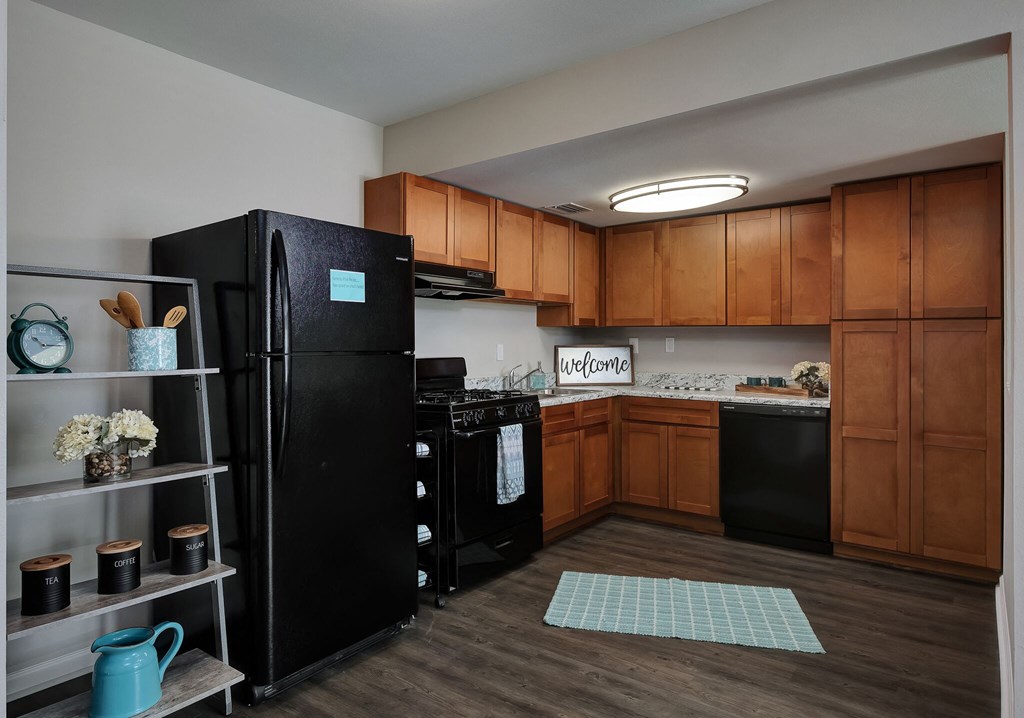 a kitchen with black appliances and wooden cabinets