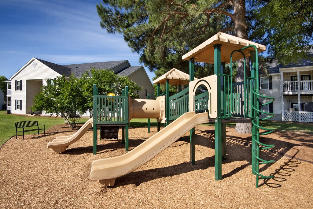 the playground at the preserve at polk apartments with a slide