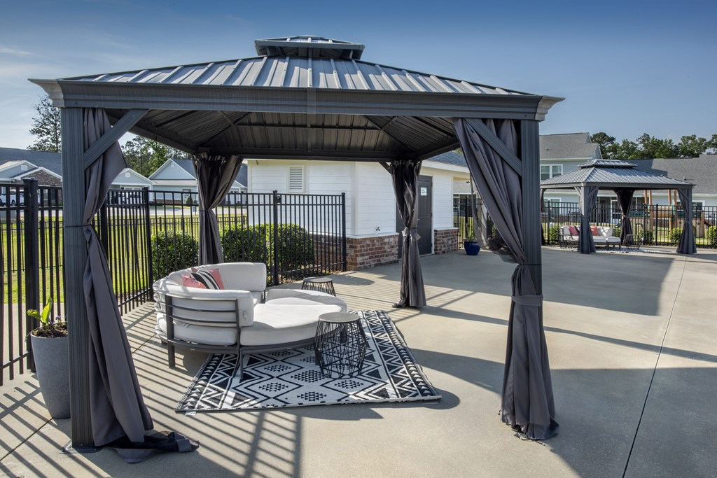 a patio with a couch and a gazebo