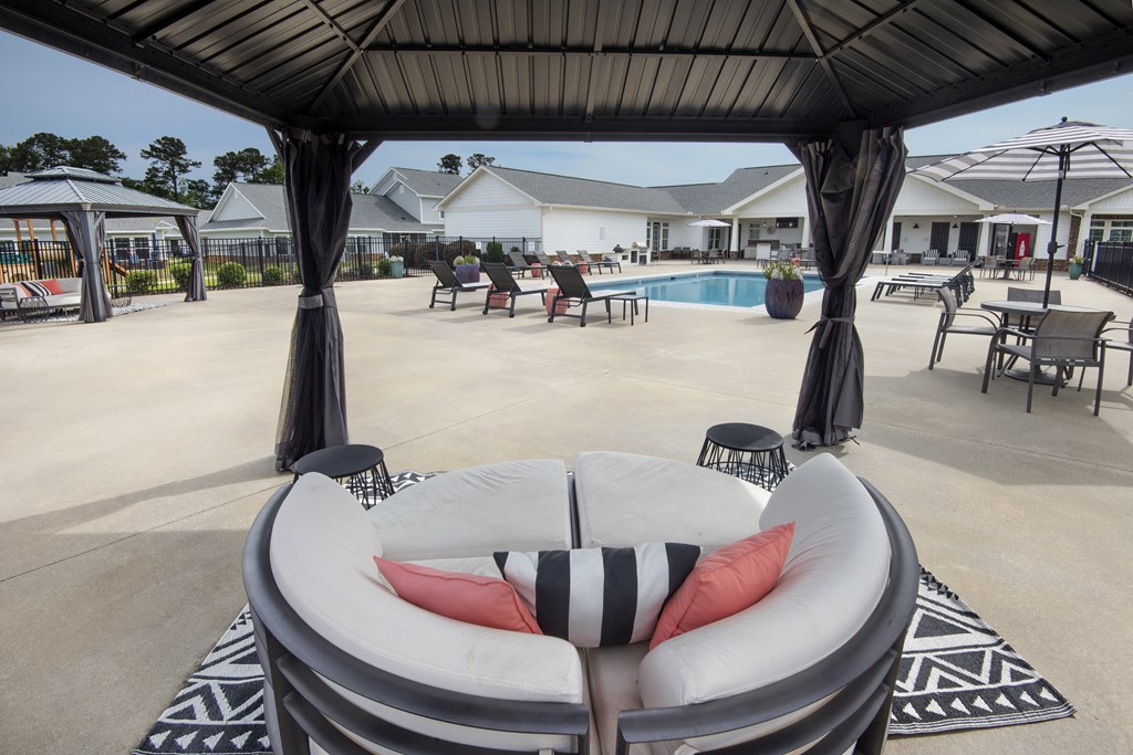 a large white chair sitting in front of a pool