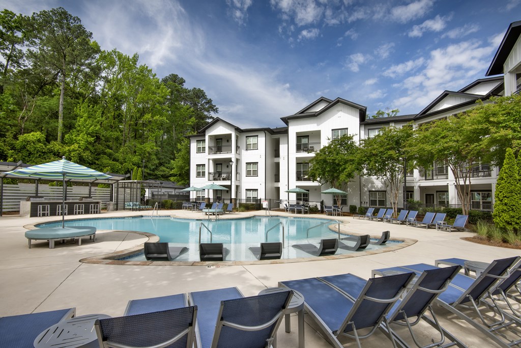 A large white building with a pool in front.