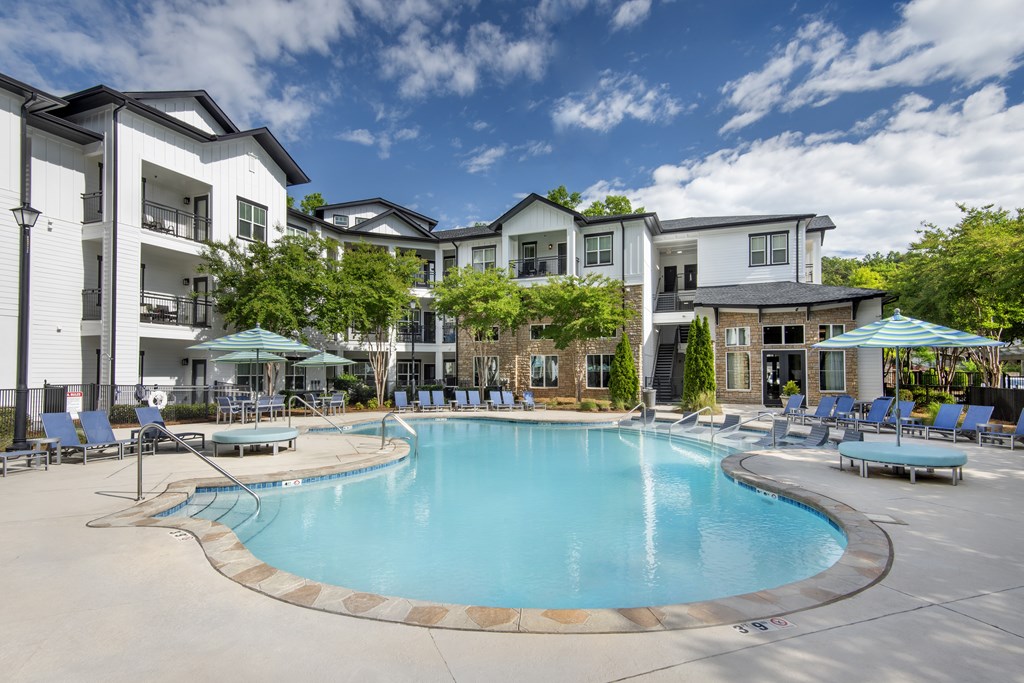 A swimming pool in front of apartment buildings.