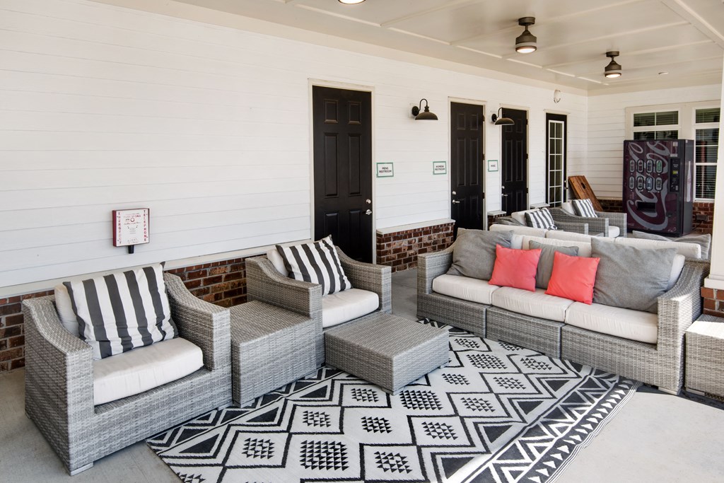 a living room with couches and chairs and a rug