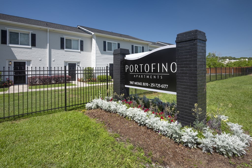a rendering of a apartments sign in front of a fence