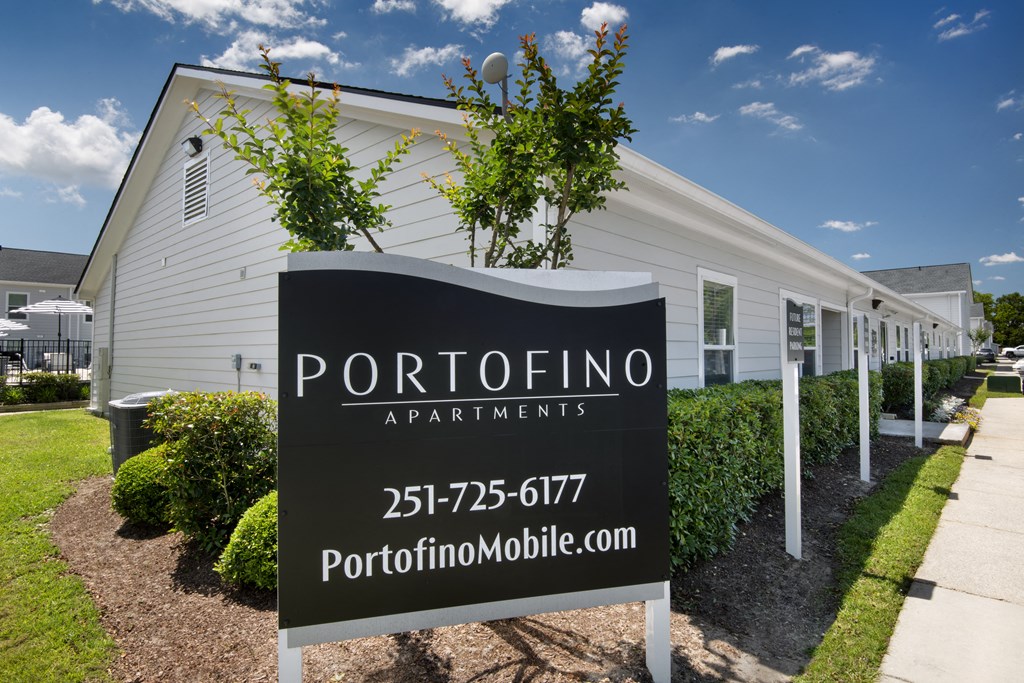 a white building with a sign apartments