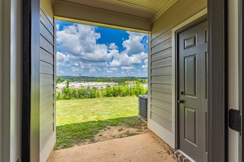 A view from a doorway looking out to a grassy area.