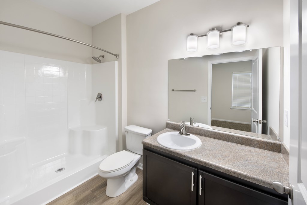 A white toilet sits next to a sink in a bathroom.