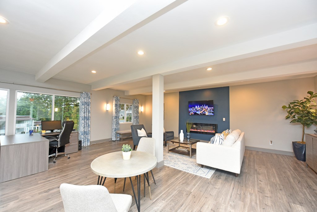 a living room with a table and chairs and a fireplace