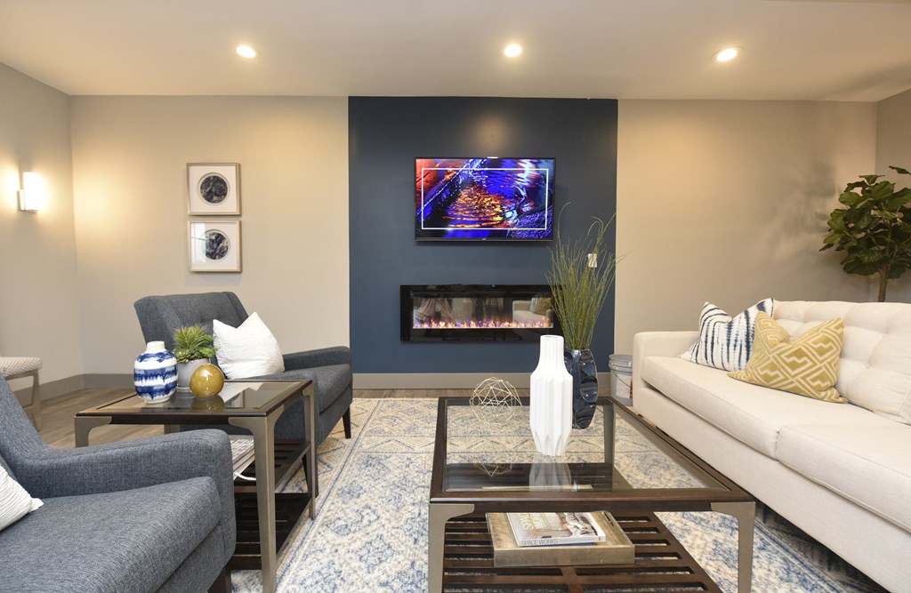 a living room with couches and chairs and a fireplace