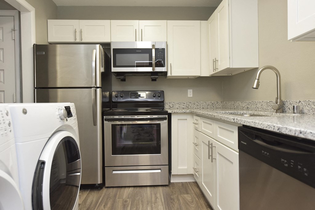 1 BR Apartments in Vestavia Hills, AL - MarQ Vestavia - Kitchen with Stainless Steel Appliances, Granite Countertops, and Hardwood-Style Flooring