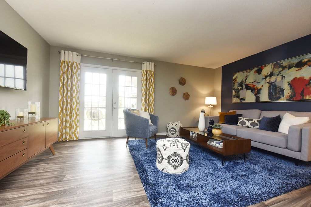 a living room with a blue rug and a couch