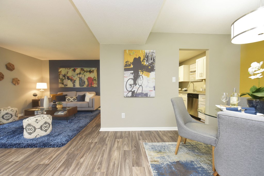 a living room with couches and chairs and a rug