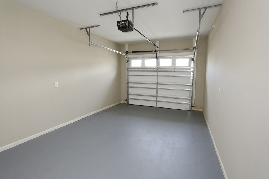 a garage with white walls and a white garage door