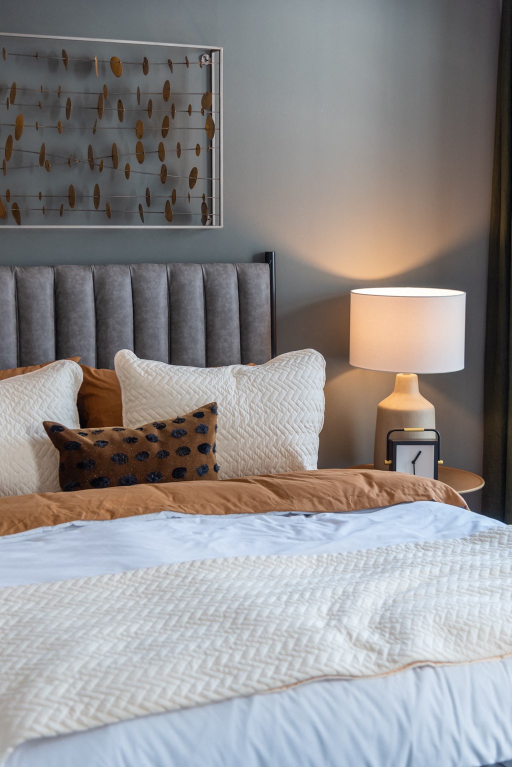 a bedroom with a bed and pillows and a lamp