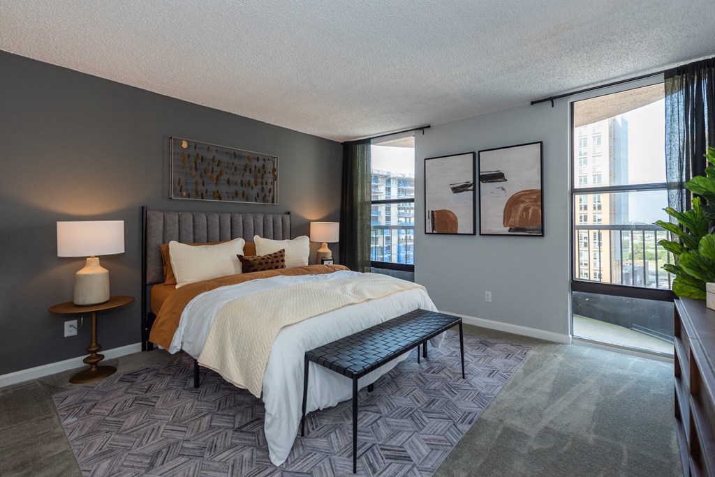 a bedroom with a large bed and a window