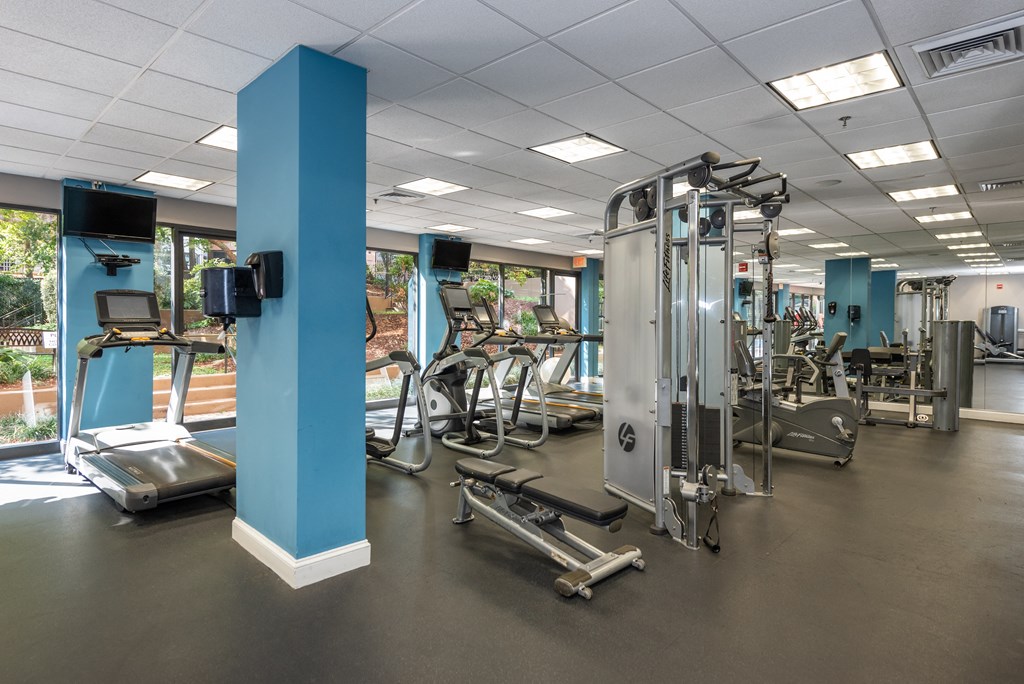 a gym with cardio equipment and weights in a health center
