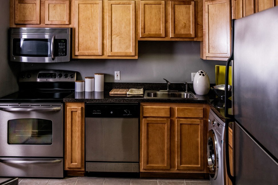 a kitchen with stainless steel appliances and wooden cabinets