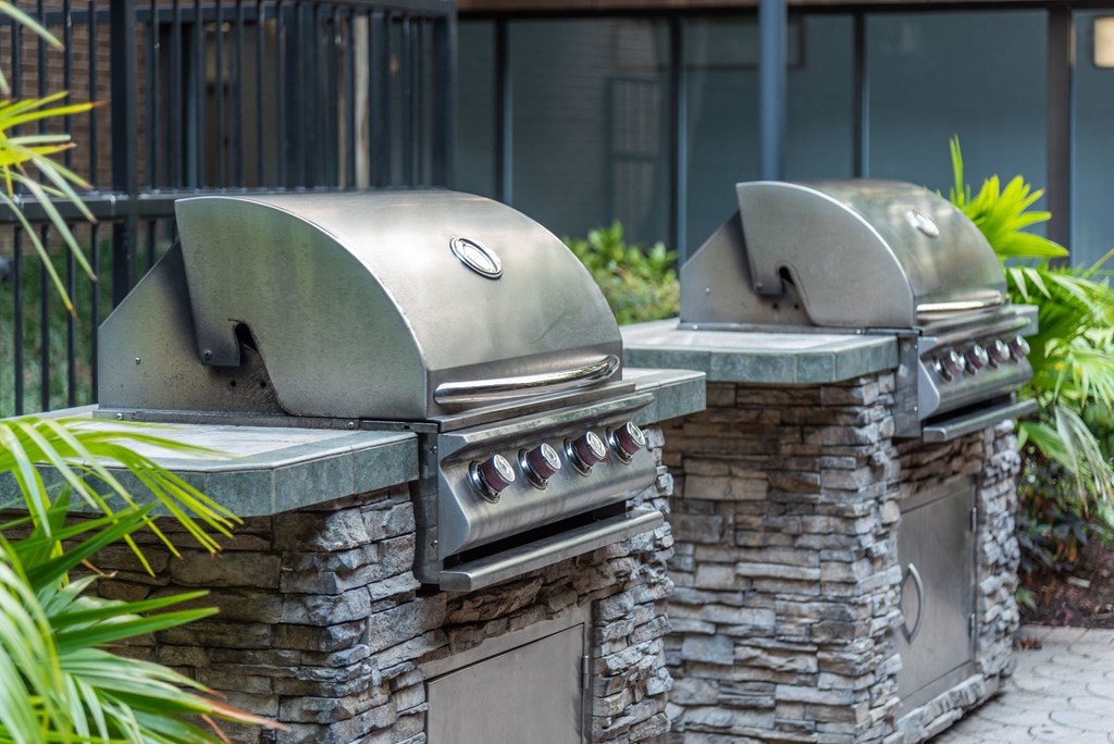 two bbq pits in the backyard of a house
