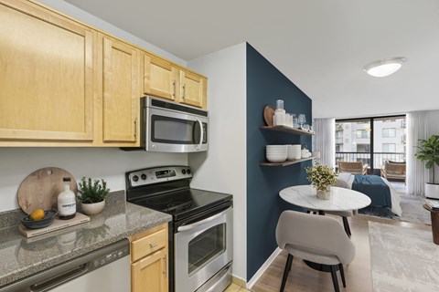 A kitchen with wooden cabinets and a black stove top oven.