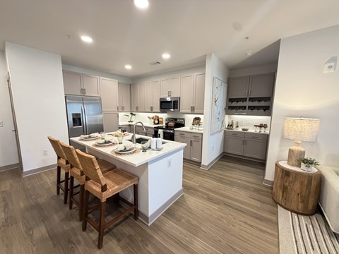 A modern kitchen with a dining table and chairs.