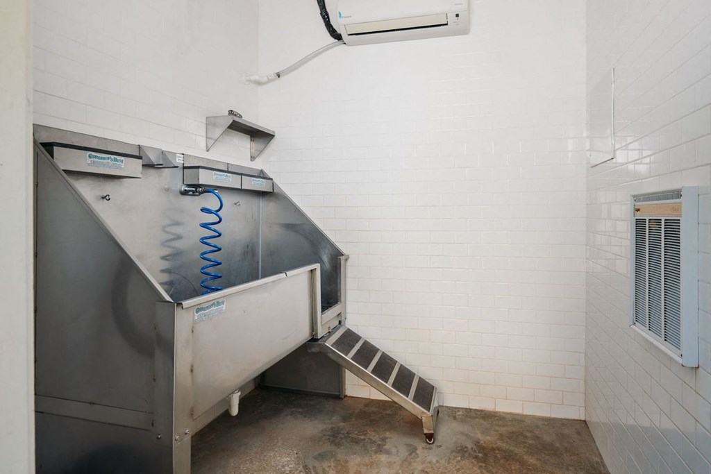 the interior of a room with a stainless steel refrigerator and stairs