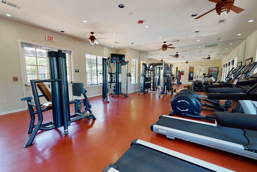 a room filled with lots of different types of exercise equipment