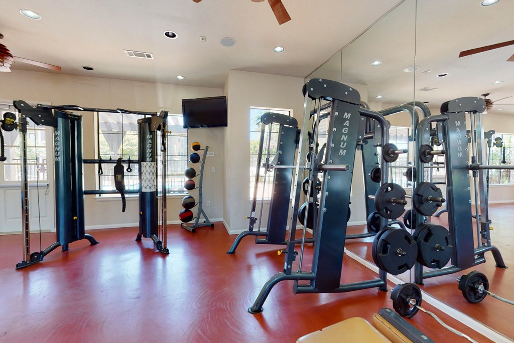 a workout room with a lot of exercise equipment