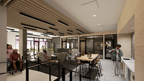 A modern dining area with people sitting and standing around the tables.