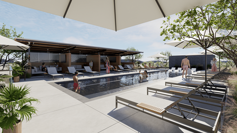 A pool area with sun loungers and a shaded area.