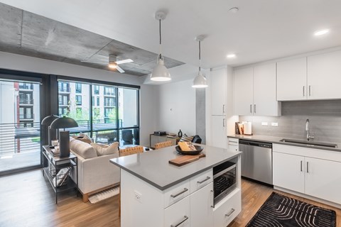 A modern kitchen with white cabinets and a large island.