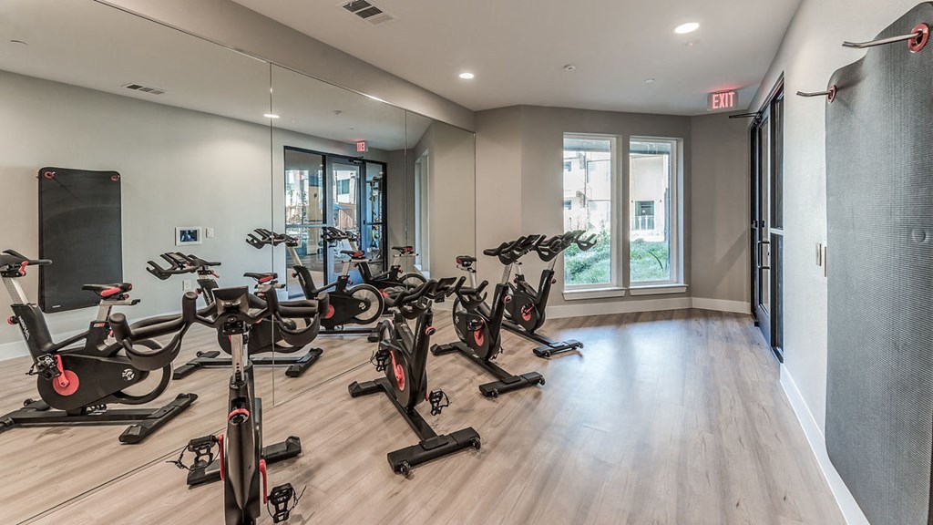 stationary bikes in the gym at soneto on western apartments