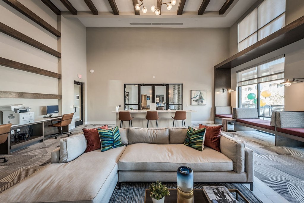 a large living room with a couch and a table