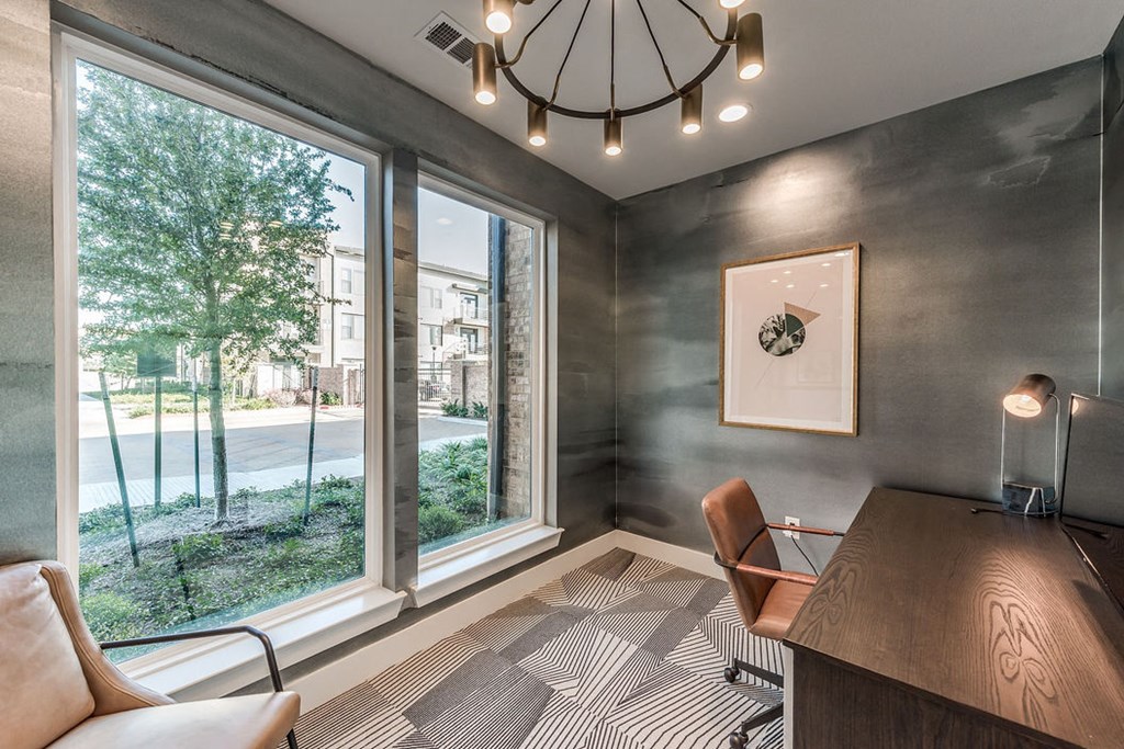 a conference room with a large window and a desk